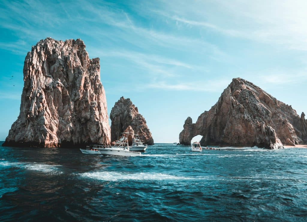 Photo of Boats on Ocean Near Rock Formations, Cabo San Lucas, B.C.S., Mexico